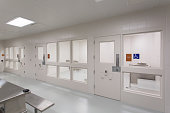 Modern Jail Holding Cell. Interior space is sparse, white minimal, and clean.