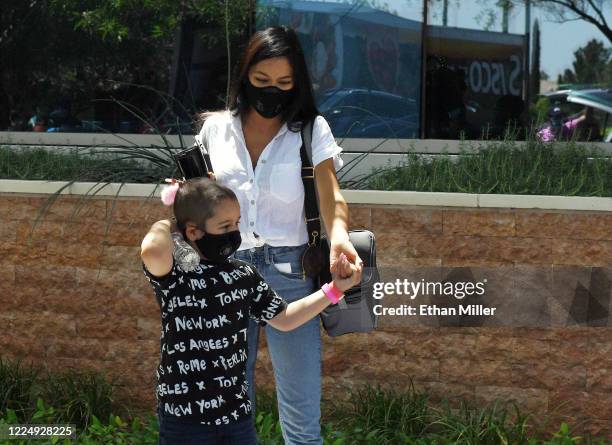 Illusionist Criss Angel's son Johnny Crisstopher Sarantakos and Shaunyl Benson come out to visit Angel as he helps to give out food and other items...