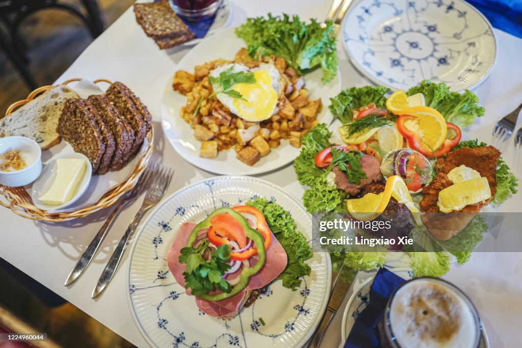 Plates of traditional Danish Smørrebrød or open sandwiches with Biksemad and breads, landmark of Copenhagen, Denmark