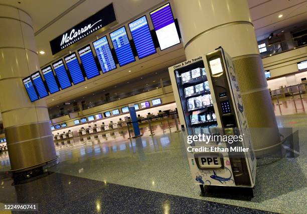 Personal protective equipment vending machine is set up in the Terminal 1 ticketing area at McCarran International Airport on May 14, 2020 in Las...