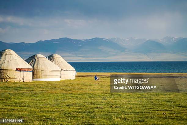 local yurts at the lakeside with mountain view, song kul lake, kyrgyzstan - yurt stock pictures, royalty-free photos & images