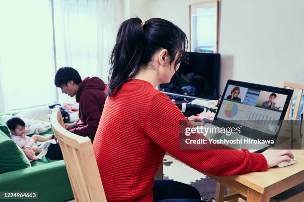 father takes care of daughter and mother is busy working from home - genderblend stock pictures, royalty-free photos & images