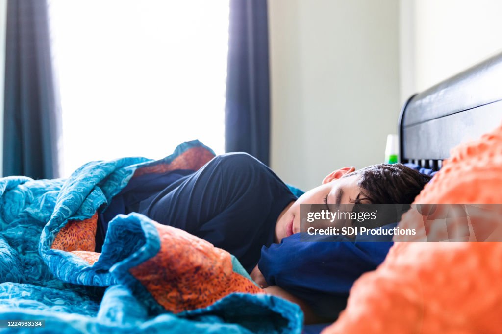 Sick male teenager sleeps comfortably