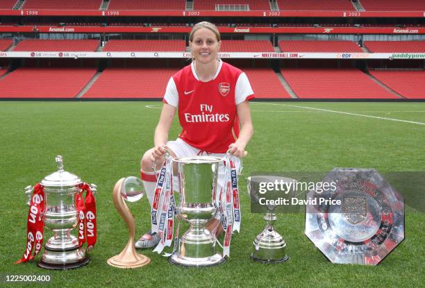 Kelly Smith of Arsenal with the Womens FA Cup Trophy, Womens UEFA Cup Trophy, Womens League Cup Trophy, Womens Premier League Trophy and the Womens...