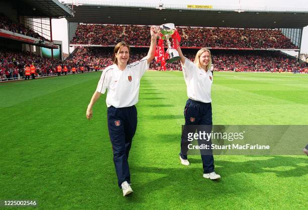 Marianne Spacey and Jayne Ludlow of Arsenal Women parade the Womens League Championship Trophy during half time of the Premier League match between...