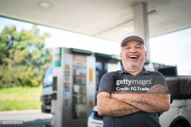 portrait of a senior man at a gas station - man cap stock pictures, royalty-free photos & images