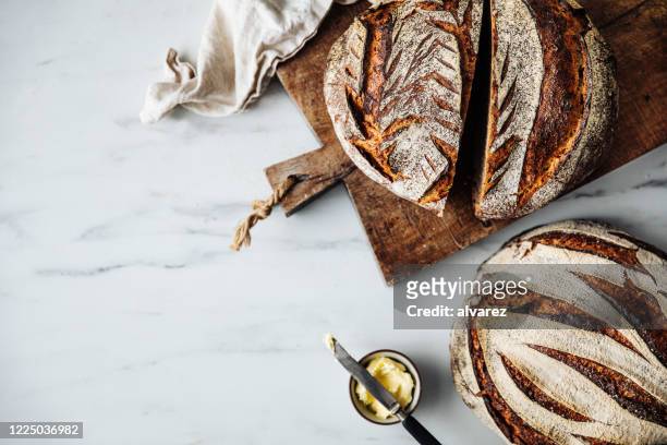 directly above view of sourdough bread and butter - kitchen bench wood stock pictures, royalty-free photos & images