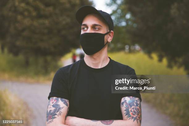 young men with mask outdoors - blank t shirt stock pictures, royalty-free photos & images