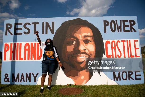 Valerie Castile stands by a portrait of her son, Philando Castile, during a memorial gathered outside the St. Anthony City Hall on July 6, 2020 in...
