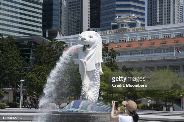 The Merlion Statue stands by Marina Bay in a near-empty Merlion Park in Singapore on Monday, July 6, 2020. Prime Minister Lee Hsien Loong vowed to...