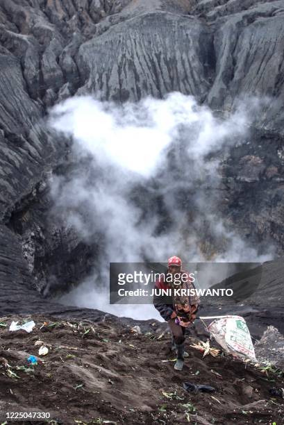 Tengger tribesman makes his way to the summit of Mount Bromo volcano to make offerings in Probolinggo, East Java province on July 7 as part of the...