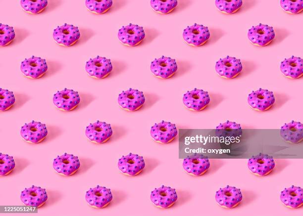 seamless pattern of glazed donuts on pink background. national doughtnuts day. made with plasticine - isometric pattern stock pictures, royalty-free photos & images