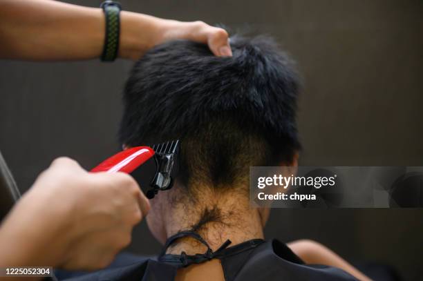 using hair clipper shave hair - shaving head stock pictures, royalty-free photos & images