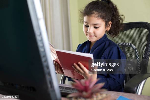Read On A Computer Kids Reading Computer Books Photos and Premium High Res Pictures ...