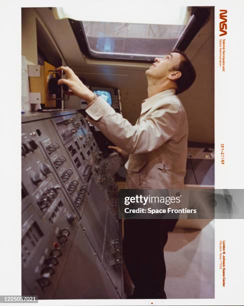 Astronaut John M Fabian, mission specialist, lifts his head to view the results of his controls manipulations at the manipulator development facility...
