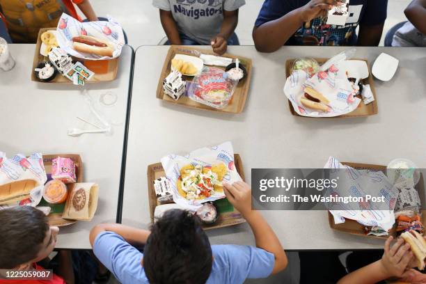 Students eat their lunch in the cafeteria at Doby Elementary School in Apollo Beach, Florida on October 4, 2019. In Hillsborough County, students pay...