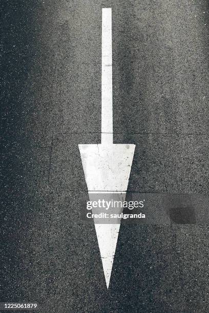 arrow symbol on the road from above - anthracite coal stock pictures, royalty-free photos & images