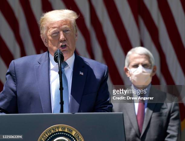President Donald Trump is flanked by Dr. Anthony Fauci, director of the National Institute of Allergy and Infectious Diseases while speaking about...