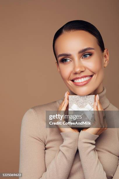 happy woman with a gift - beautiful woman christmas stock pictures, royalty-free photos & images