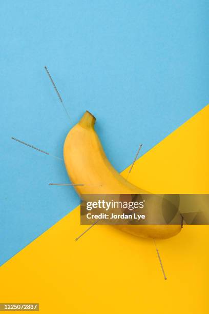 acupuncture a banana - acupuncture needle stock pictures, royalty-free photos & images
