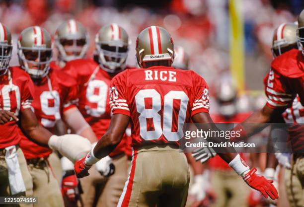 Jerry Rice of the San Francisco 49ers is greeted by his teammates before a National Football League game against the Buffalo Bills played in...