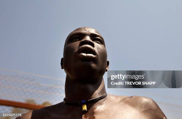 Member of the Dinka tribe from Bor attends the final of Sudan's first commercial wrestling league between his tribe and the Mundari from Central...