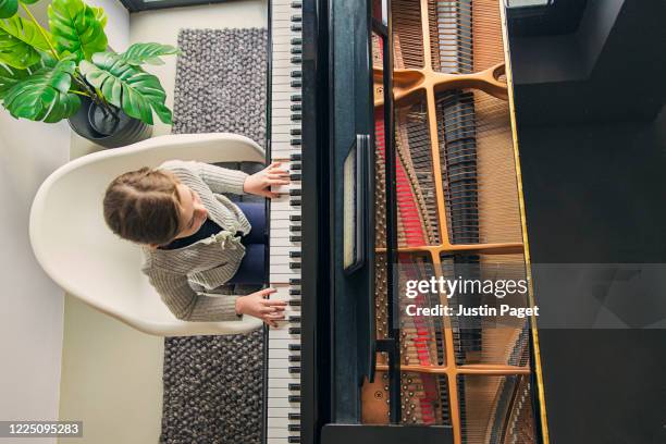 young girl playing her grand piano - music talent stock pictures, royalty-free photos & images