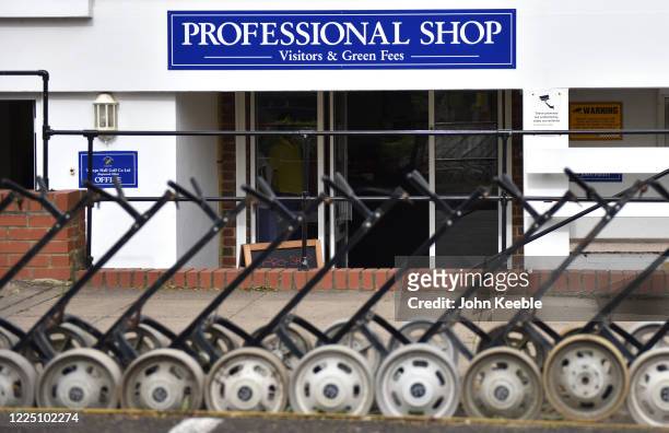 Golf trolleys are stored outside the professional shop as golf courses reopen in England under government guidelines during the Coronavirus pandemic...