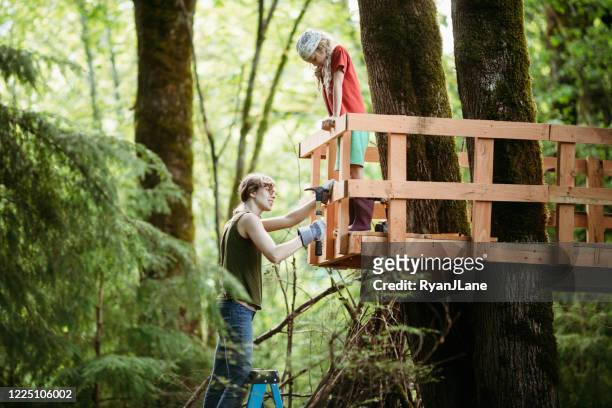 mor och dotter arbete i backyard tree fort - tree house bildbanksfoton och bilder