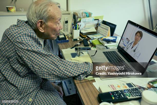senior use laptop for remote medical treatment with doctor at home - 109 stock pictures, royalty-free photos & images