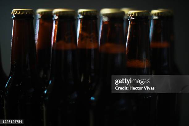 Bottles of craft beer are seen on May 15, 2020 in Mexico City, Mexico. Considered nonessential, brewing has to stop during the coronavirus pandemic...