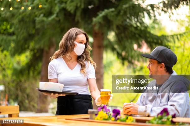 waitress wearing protective equipment for covid - bar reopening stock pictures, royalty-free photos & images