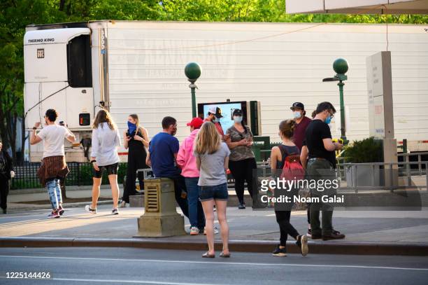 People walk near a makeshift morgue outside Lenox Health Greenwich Village hospital on May 15, 2020 in New York City. COVID-19 has spread to most...