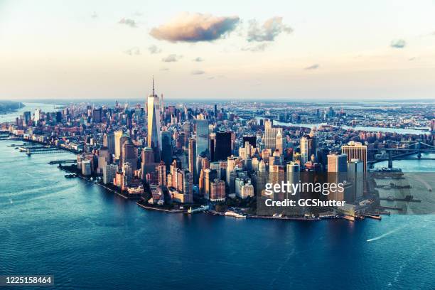 aerial views of manhattan island, new york - cities under covid-19 series - urban skyline stock pictures, royalty-free photos & images