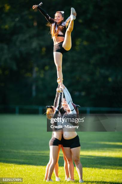 cheerleader human pyramid outdoor training - teen cheerleader stock-fotos und bilder