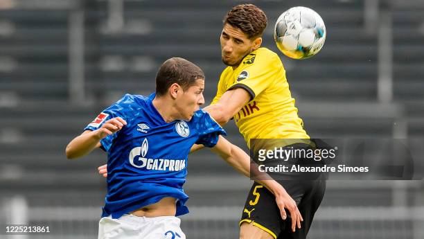 Achraf Hakimi of Borussia Dortmund challenges Amine Harit of FC Schalke 04 during the Bundesliga match between Borussia Dortmund and FC Schalke 04 at...