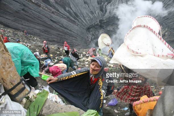 Tengger tribe people make their way to the summit of Mount Bromo volcano to make offerings in Probolinggo, East Java province, Indonesia on July 7 as...