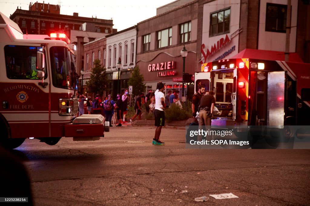 Sheriff's deputies stand outside an ambulance after a red...