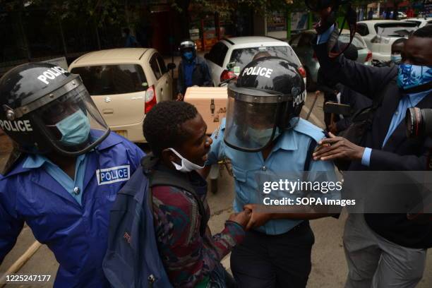 Policemen arrest a protester during the demonstration. Kenyan police have fired tear gas and detained protesters demanding an end to police brutality.