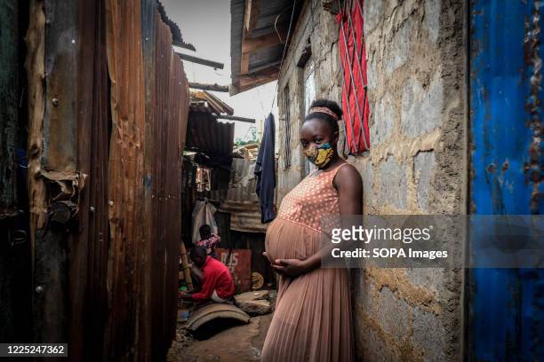 Young mother is seen holding her 8 months baby bump in Kibera Slums Nairobi. Some research indicates that up to a third of more of girls aged between...