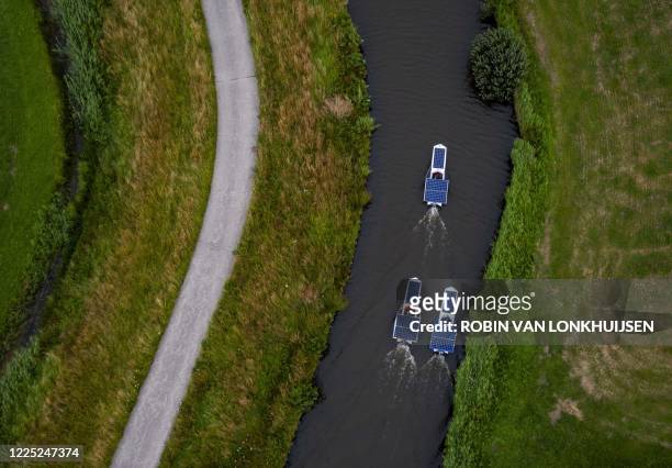An aerial picture shows students sailing with solar boats along all Frisian Elfstedentocht during the Young Solar Challenge in Hindeloopen, on July...