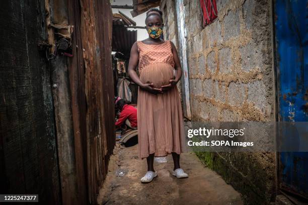 Young mother is seen holding her 8 months baby bump in Kibera Slums Nairobi. Some research indicates that up to a third of more of girls aged between...