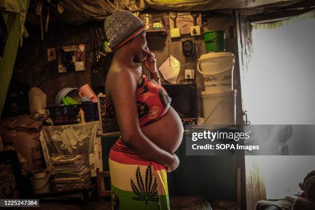 Year old Viela Akinyi is seen holding her baby bump inside her home in Kibera Slums. Some research indicates that up to a third of more of girls aged...