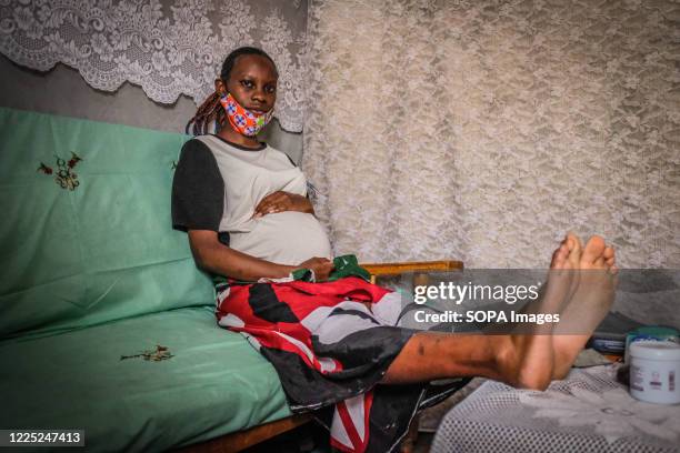 Year old mother Mercy Kwamboka is seen holding her 7 month old baby bump in Kibera Slums Nairobi. Some research indicates that up to a third of more...