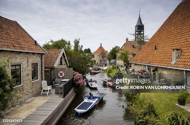 Students sail with solar boats along all Frisian Elfstedentocht during the Young Solar Challenge in Hindeloopen, on July 7, 2020. - The 220-kilometer...