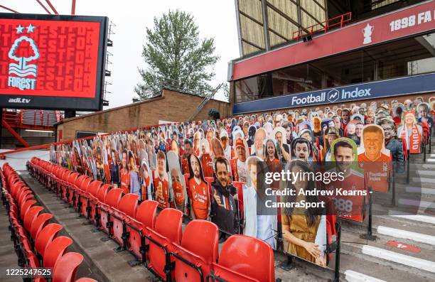 Harry and Meghan amongst cut outs of supporters lining the stands during the Sky Bet Championship match between Nottingham Forest and Fulham at City...