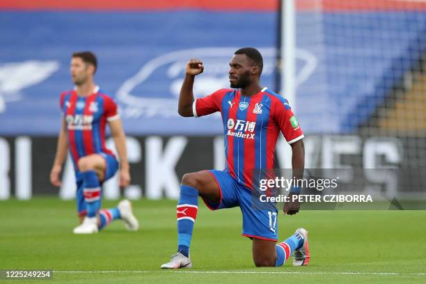 Crystal Palace's Zaire-born Belgian striker Christian Benteke takes a knee to show solidarity with the Black Lives Matter movement and to protest...