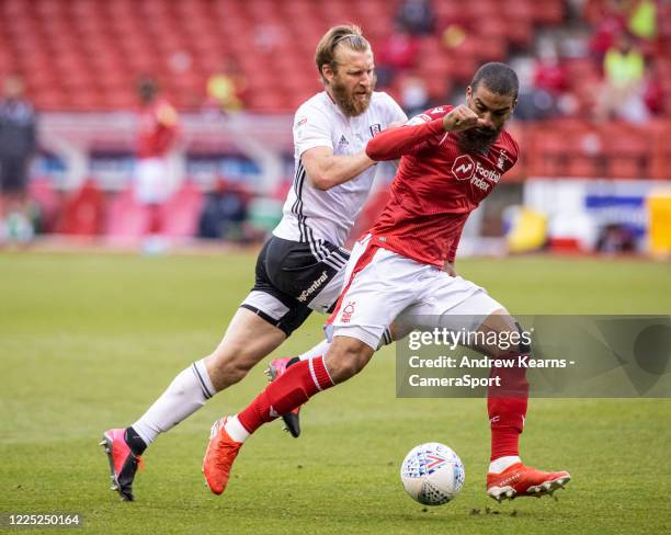 Nottingham Forest's Lewis Grabban competing with Fulham's Tim Ream during the Sky Bet Championship match between Nottingham Forest and Fulham at City...