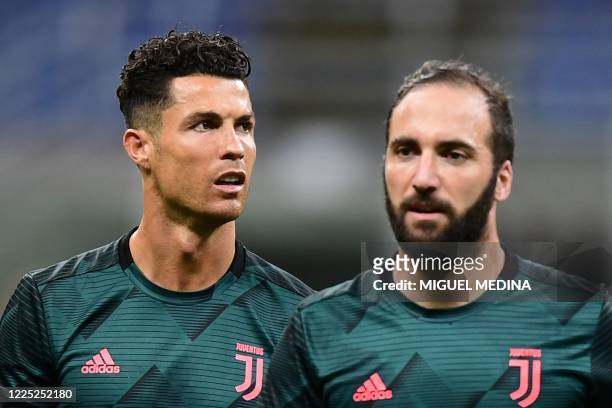 Juventus' Portuguese forward Cristiano Ronaldo and Juventus' Argentinian forward Gonzalo Higuain warm up prior to the Italian Serie A football match...