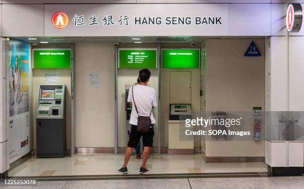 Clients at the Hang Seng Bank ATM in Central MTR subway in Hong Kong.